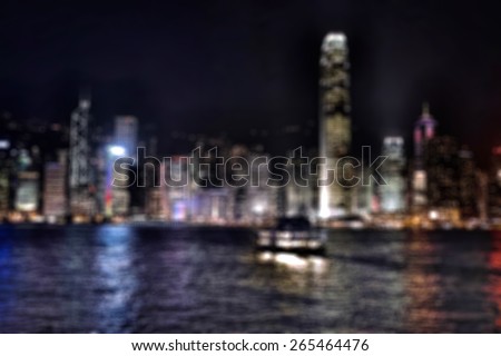 Blurred background of Hong Kong Victoria harbor and night skyline with ferry 