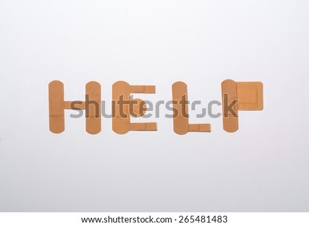 bandages forming the word help over white background