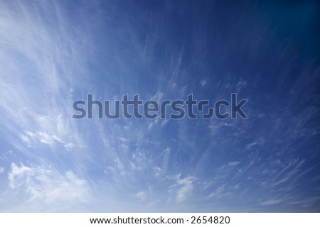 deep blue sky with feather clouds