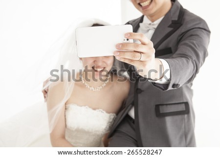 Bride and groom taking picture of themselves