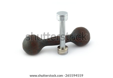 Two different dumbbells, modern steel and silver and old iron isolated on white background. Sports equipment closeup
