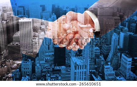 Handshake between two business people against high angle view of city