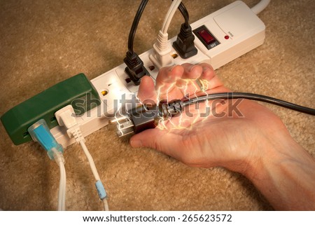 Electrocuted man in a home accident where the man tried to plug too much into a surge protector cord. Royalty-Free Stock Photo #265623572