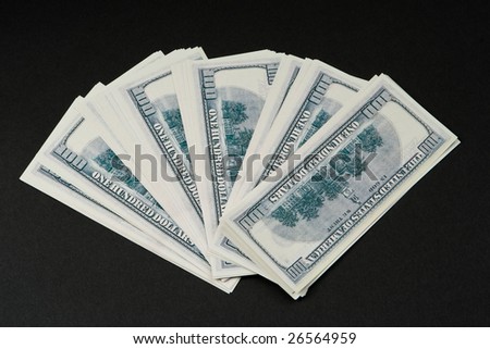 Pile of dollars against a dark background