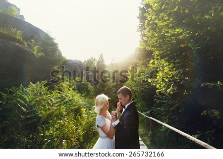 Wedding couple in a forest in the mountains at sunset