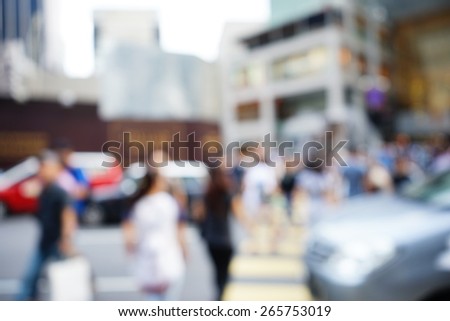 Blurred image of people moving in crowded night city street with sopping malls. Malaysia. Blur effect and soft focus