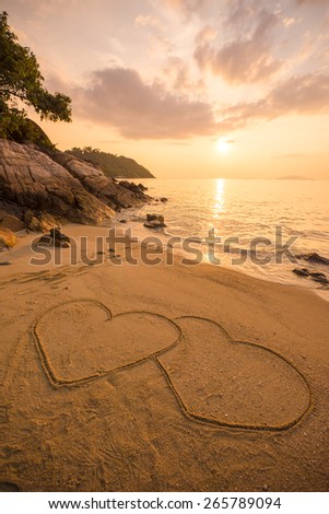 Heart of love on the beach in the sunset.