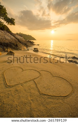 Heart of love on the beach in the sunset.