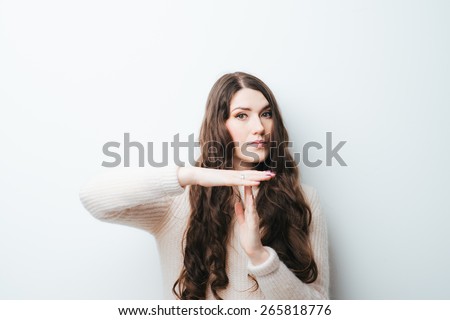 beautiful long-haired girl asks timeout on a white background