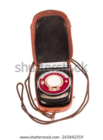 Old exposure meter in leather case. Isolated on a white background.
