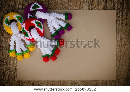 garland knitting and brown paper on cement background, vintage style