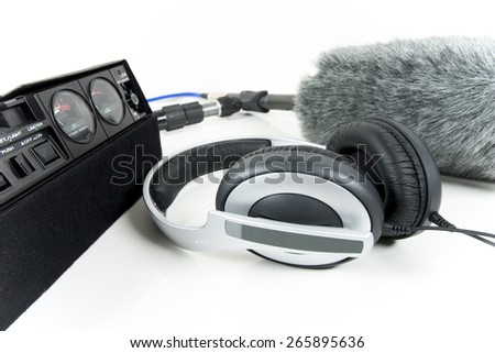 Cassette recorder, boom mic and headphones over white
