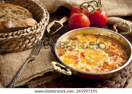 Menemen Turkish breakfast food egg, tomatoes and pepper in pan with concept background Royalty-Free Stock Photo #265907195