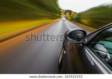 Sport car driving fast. Royalty-Free Stock Photo #265922192