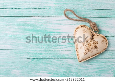 Decorative  heart on turquoise painted wooden background. Place for text. 
