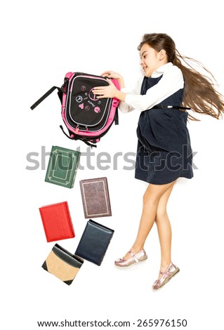 Conceptual isolated photo of cute schoolgirl emptying backpack full of books