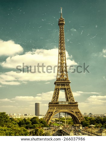 Shabby vintage photo of Eiffel Tower in Paris, France. Old majestic Eiffel construction is a top landmark of Paris. Great Tour Eiffel on the sky background. Retro cityscape in summer.