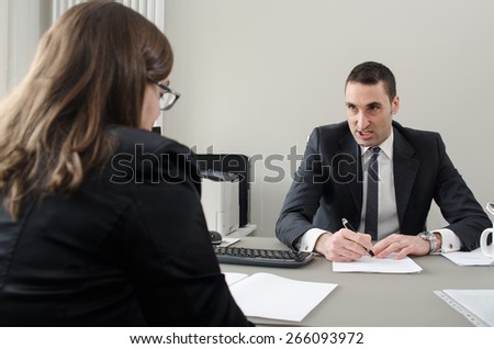 Co-workers discussing business plan in office 