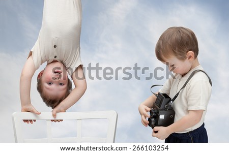 a young boy with an old camera and his model
