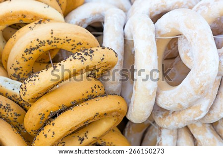 Bundles bagels with poppy seeds and sugar. Picture taken at the spring fair under the open sky. Close-up.