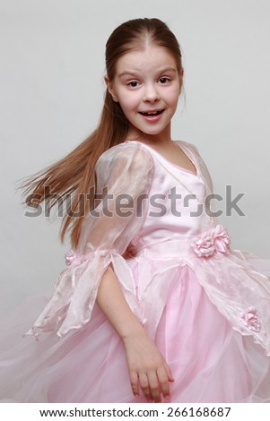Beautiful kid wearing pink dress as a princess