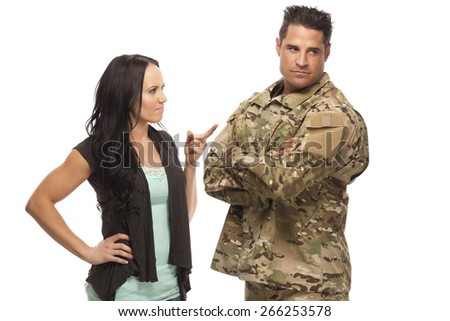 Young military couple arguing against white background