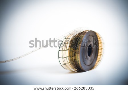 35mm movie reel, unrolled with selective focus, vintage color look and feel and copyspace