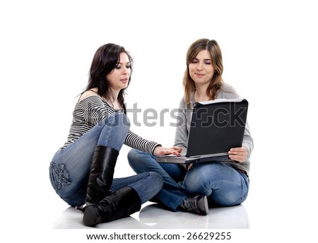 Two female young students working with a laptop