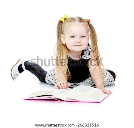 Adorable little girl with pigtails reading a book.- isolated on white background