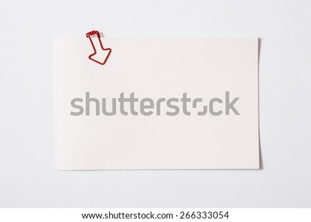 white sheet of paper for notes and paper clip