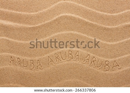 Aruba inscription on the wavy sand, as background