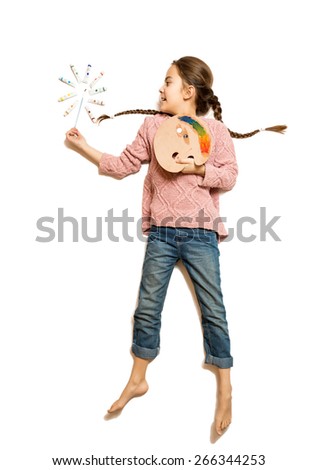Isolated shot of cute girl holding palette and paintbrush like magic wand 