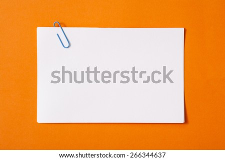 white sheet of paper for notes and paper clip