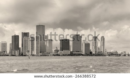 Miami skyline panorama in black and white in the day with urban skyscrapers and cloudy sky over sea 