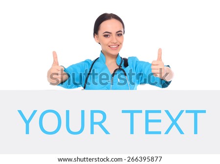 Young - professional and cheerful female doctor standing over big blank billboard isolated on white.