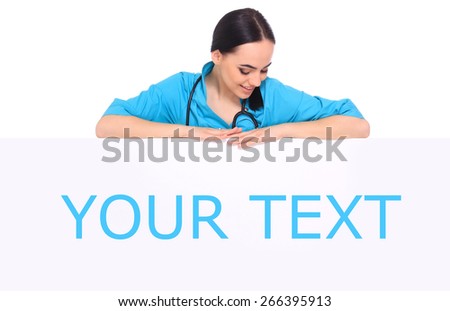 Young professional and cheerful female doctor standing over big blank billboard isolated on white