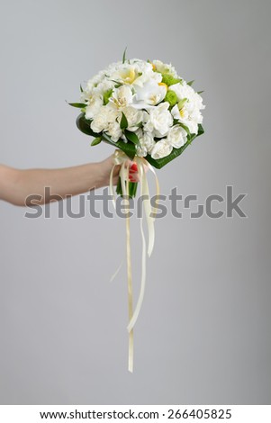 Nice and beautiful bride bouquet in the hand