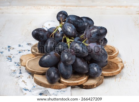 black Grapes on wooden table.  close up