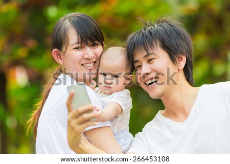 Happy family try to take a photo : selfie.