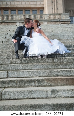 an image of bride and groom the stairs outdoors