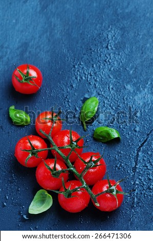 Fresh tomato on the black table, selective focus