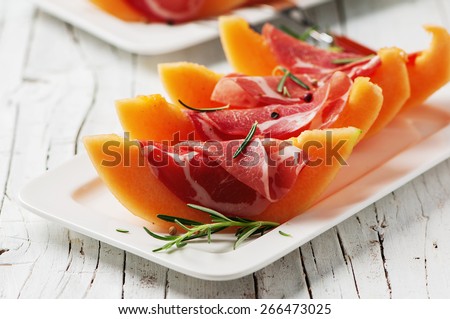 Concept of italian food with melon and prosciutto, selective focus Royalty-Free Stock Photo #266473025