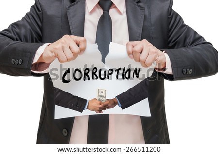 Businessman ripping up the CORRUPTION sign with Hand shake between a businessman and dollar money on white background