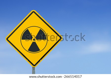 Radioactive symbol yellow road sign on sky background