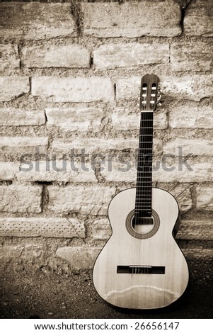 Classic guitar over old brickwall