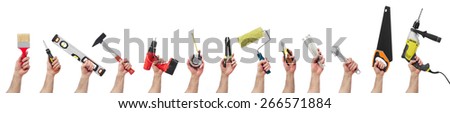 Hands raised holding different tools Royalty-Free Stock Photo #266571884