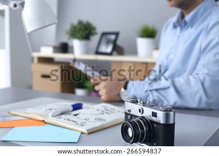 Photographer processing pictures sitting on the desk