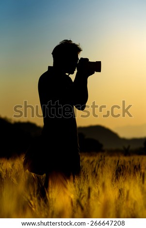 Silhouette of  photographer during in sunset.