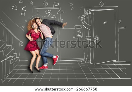 Happy valentines love story concept of a romantic couple sharing headphones and listening to the music on the stairs too loud for neighbors, against chalk drawings background.