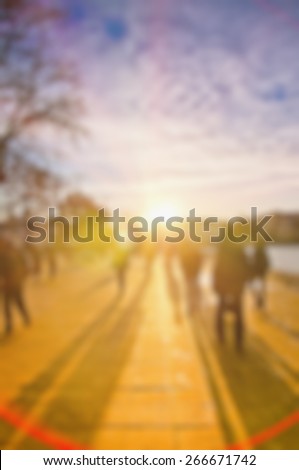 people with long shadows, street on sunset, blur background